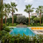 How To Turn Your Pool Area Into A Lush Tropical Retreat